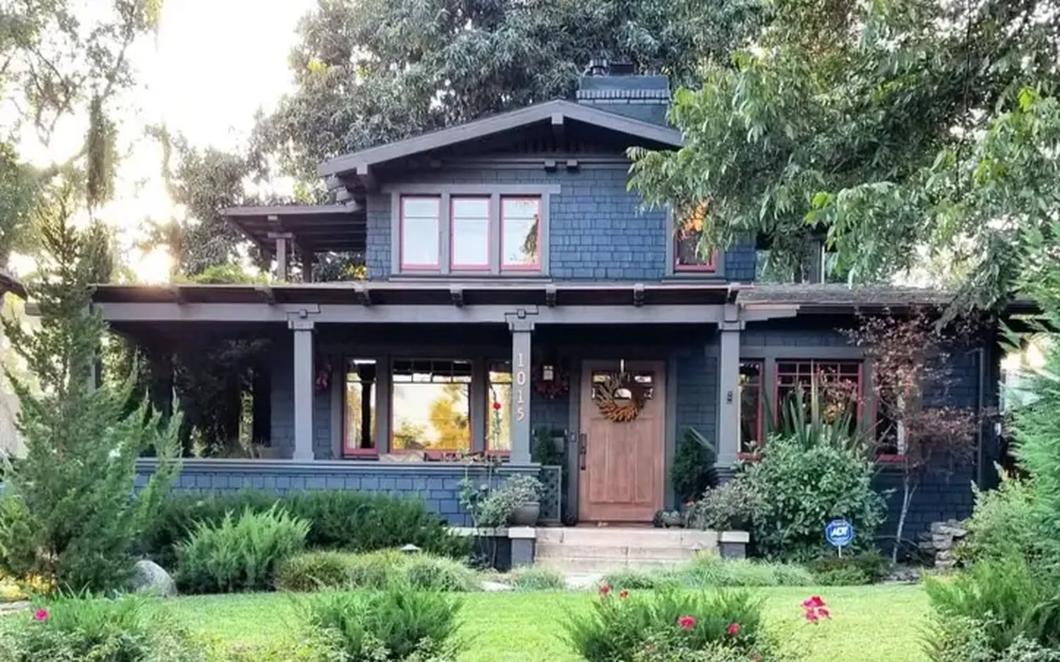 Renovated craftsman home with a deep front porch and landscaped garden